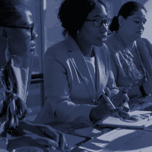 A photo of an attorney speaking to a client with a deep blue overlay