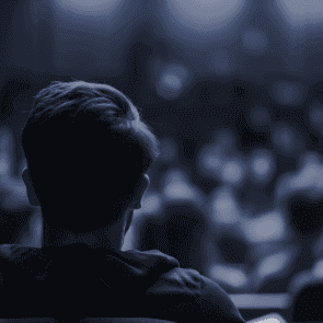 The back of a students head at a seminar with a deep blue overlay