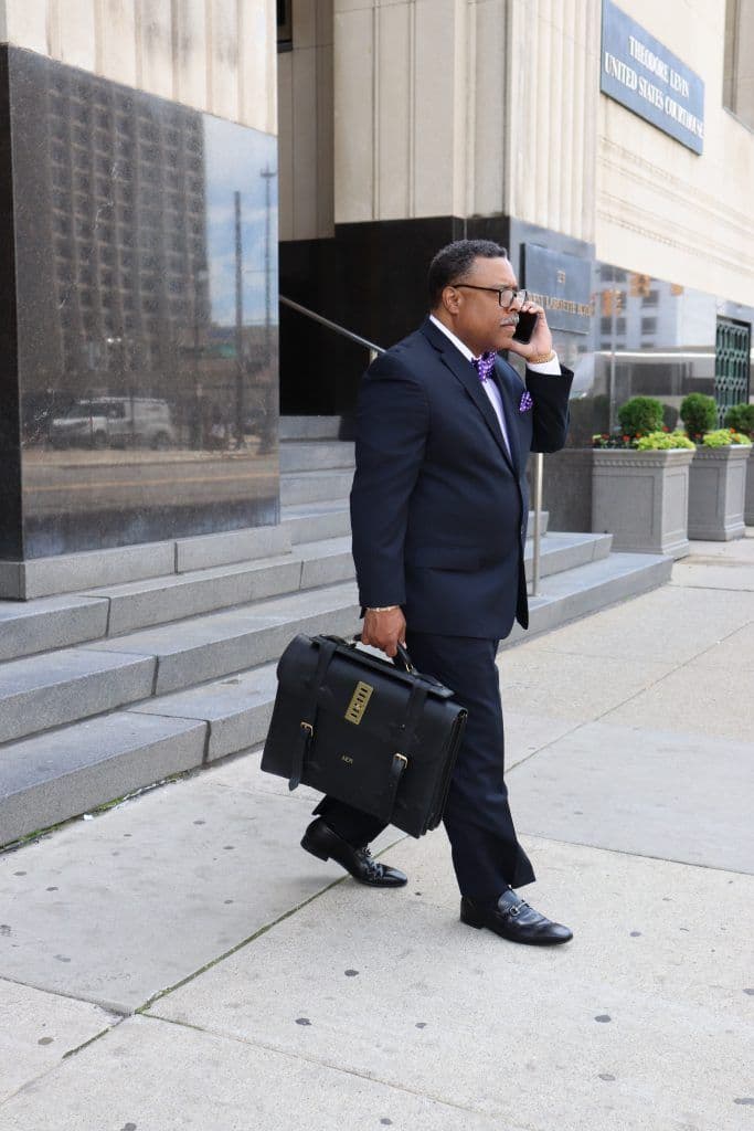 Arnold Reed walking out of the courthouse while on the phone with a client