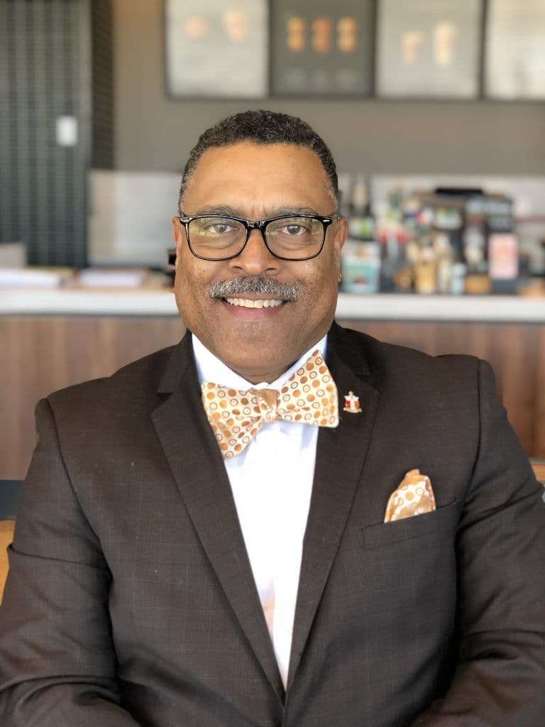 Attorney Arnold Reed posing for a photo in a coffee shop