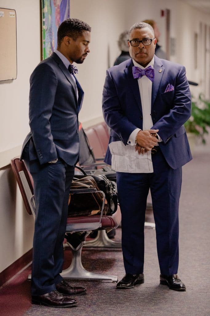 Attorney Arnold Reed and Attorney Arnold Reed II waiting between sessions in the courtroom